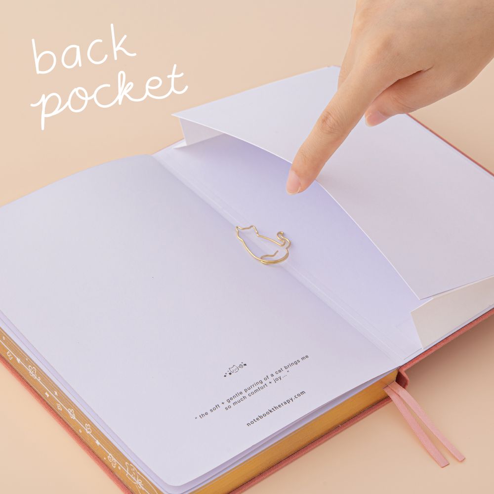 Hand opening the expandable back pocket of the tsuki neko neko bullet journal