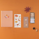 Flatlay of Tsuki Four Seasons: Autumn Collector’s Edition 2022 Bullet Journal with the Tsuki Nara Washi Tape Set