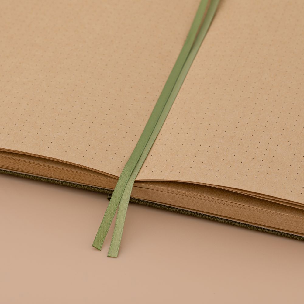 Close up of 2 green ribbon bookmarks on kraft paper