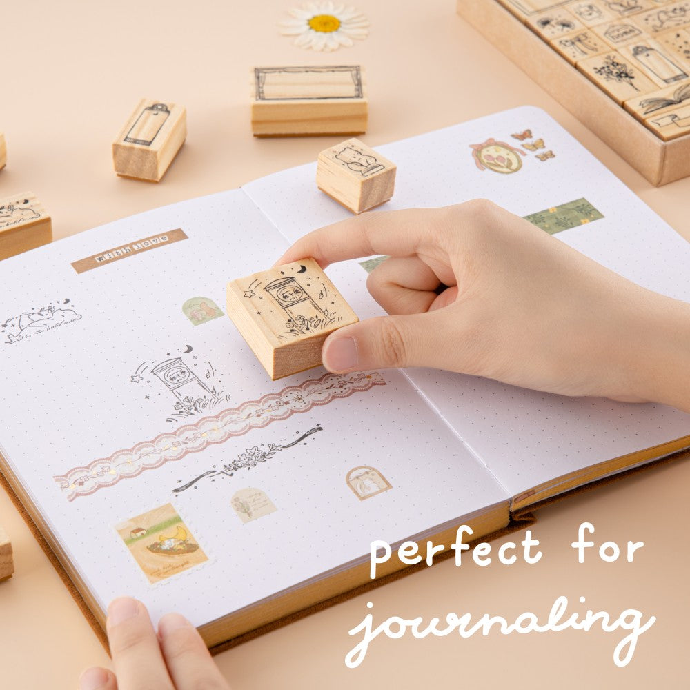 Hand stamping post box stamp on bullet journal with lettering that says ‘perfect for journaling