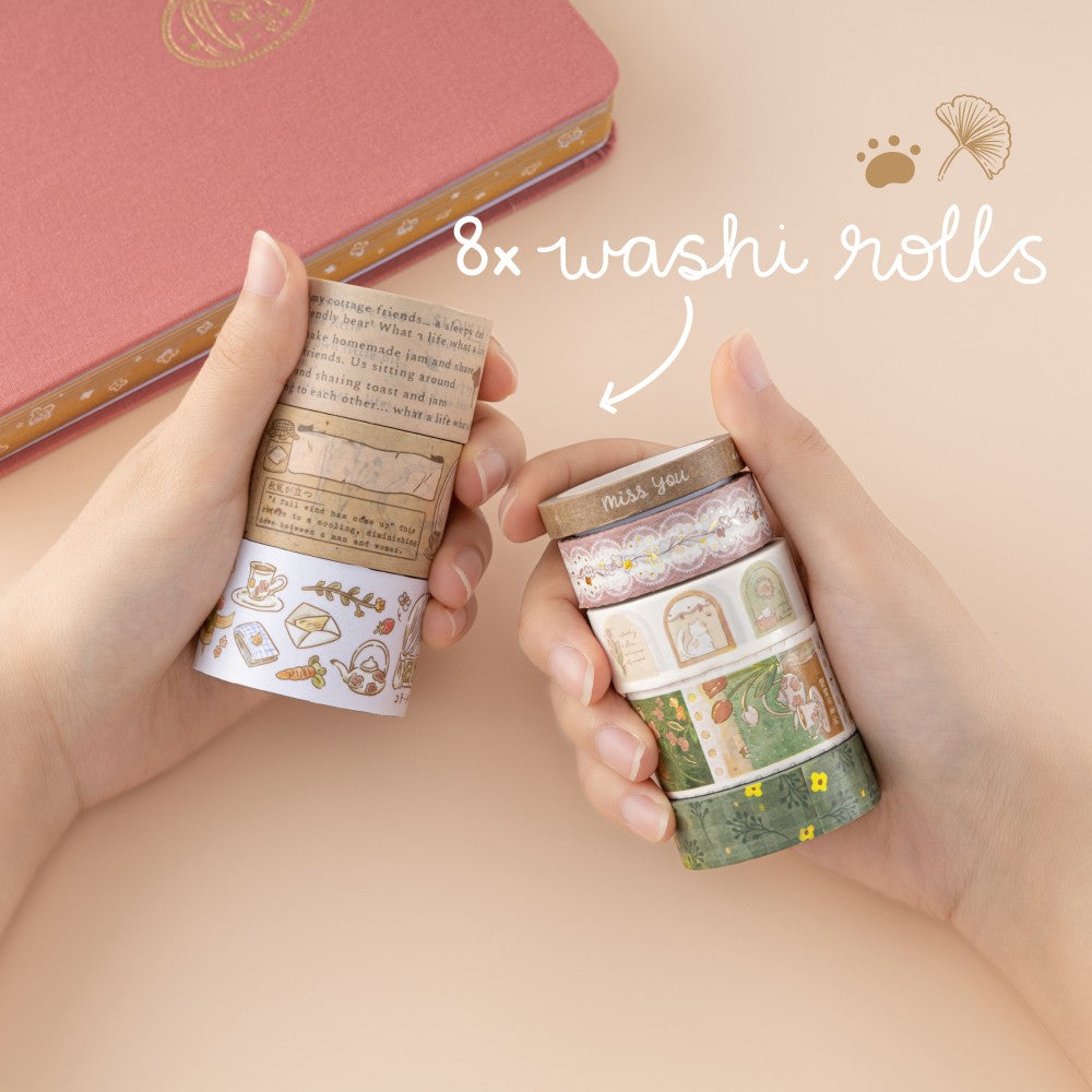 Hands holding 8x cottage core washi tape rolls