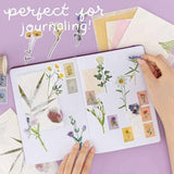 Pressed flower stickers and flower stamp stickers on bullet journal with text “perfect for journaling”