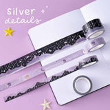 Tsuki ‘Falling Star’ Washi Tape Set with silver details rolled out on open bullet journal page with stars on purple background