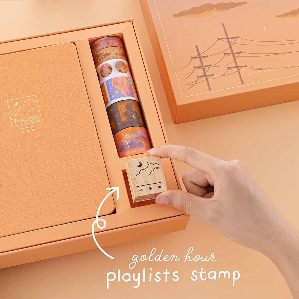 Hand holding golden hour playlist stamp from the Golden Hour bullet journal box set