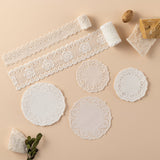Rolls of lace and doilies on beige background