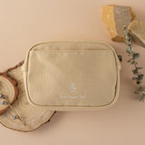 Cream Hinoki travel pouch with logo embroidered in white