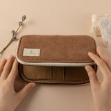 Hand opening brown corduroy pencil case