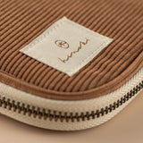 Close up of embroidered Hinoki label on corduroy pouch