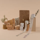Styled photo of Hinoki collection including Travel Notebook, washi tapes and stamps