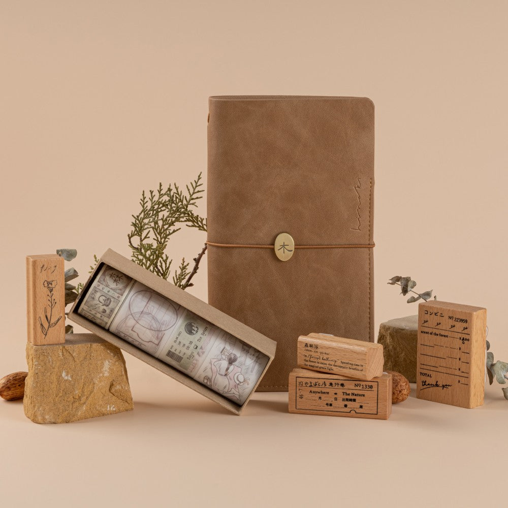 Styled photo of Hinoki collection including Travel Notebook, washi tapes and stamps