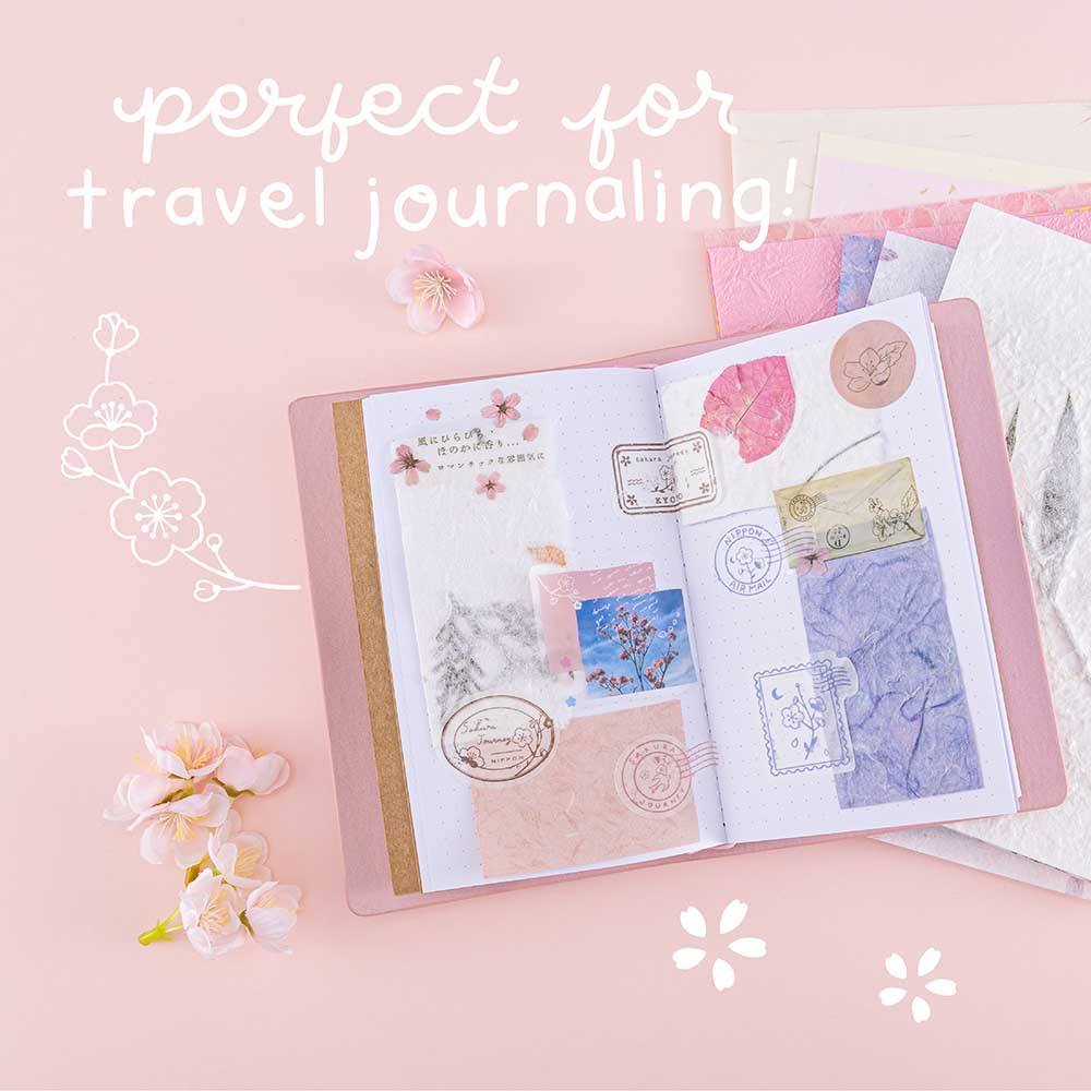 Tsuki ‘Sakura Journey’ Scrapbooking Set perfect for travel journaling on Tsuki ‘Sakura Journey’ Limited Edition Travel Notebook with cherry blossoms on pink background