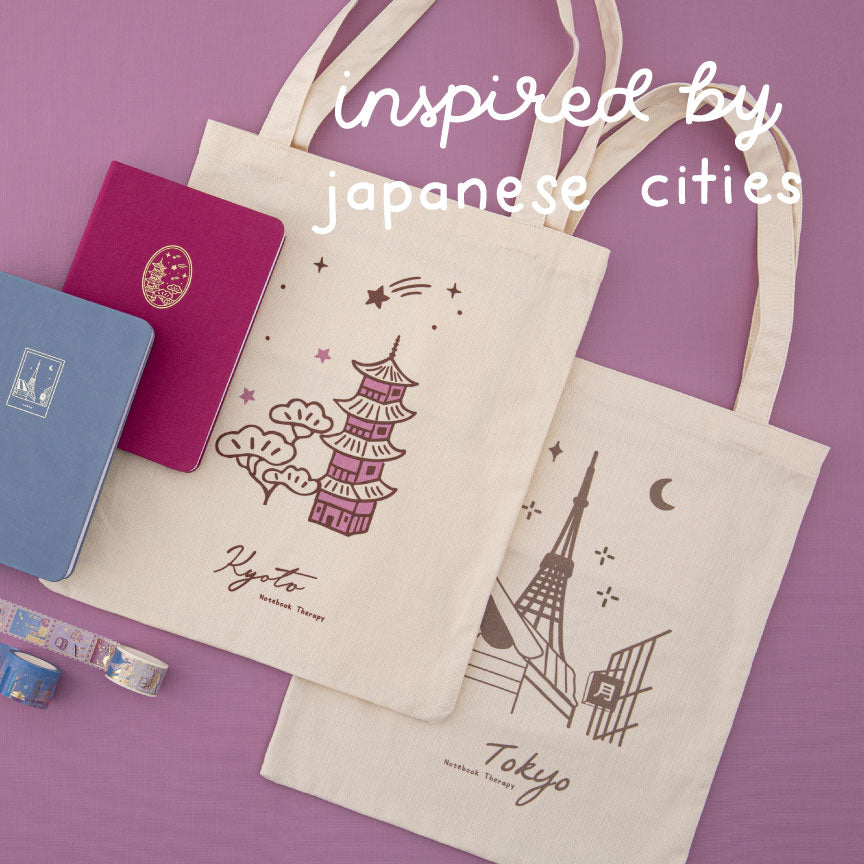 Two tote bags on pink background with white text that says “inspired by Japanese landscapes”