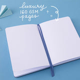Lay flat bullet journal notebook with 2 blue ribbon bookmarks and the words “Luxury 160gsm pages” written in white
