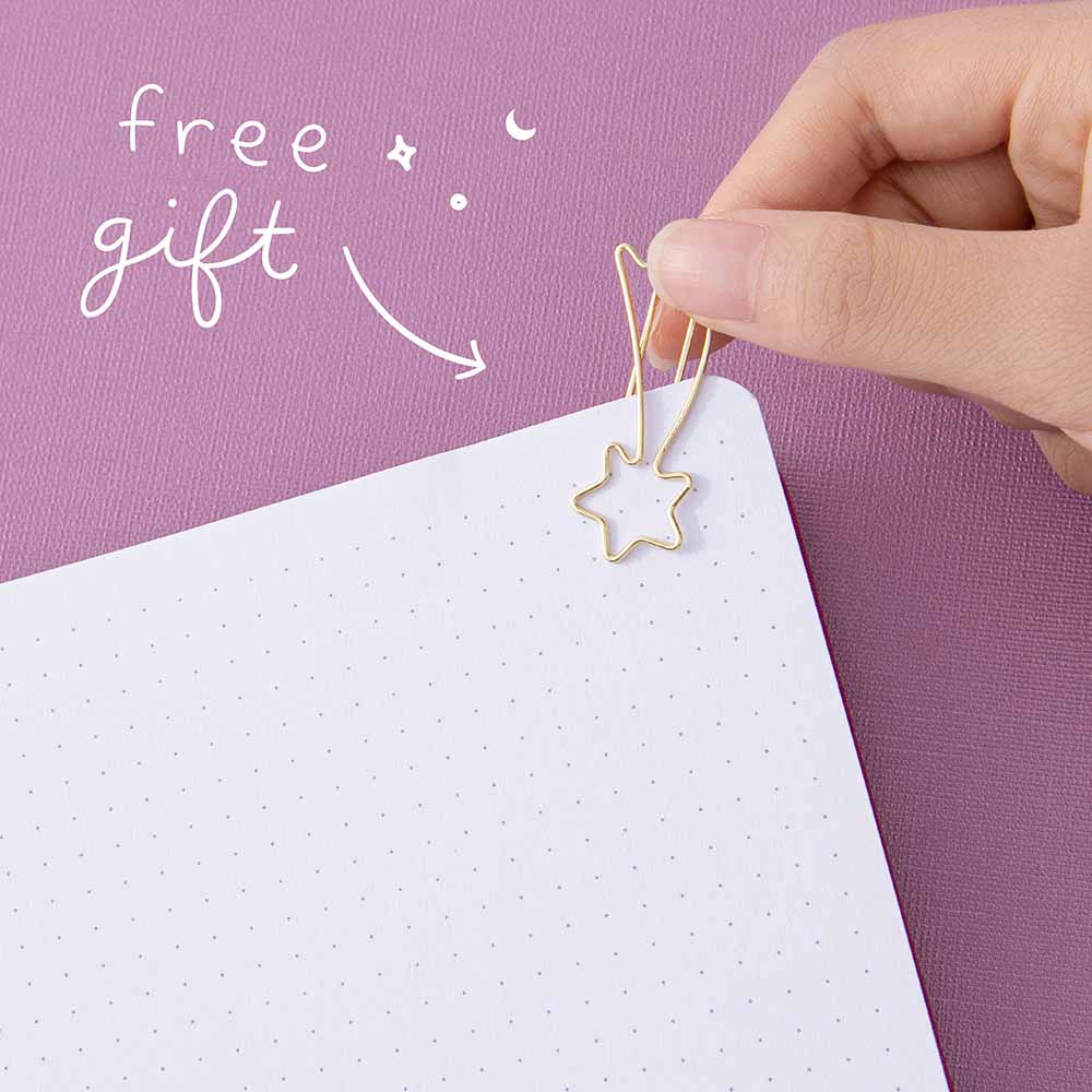 Shooting star gold paperclip on a page with the text “free gift” in white