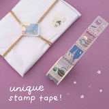 Stamp washi tape roll on pink background with words “unique stamp tape!” written in white