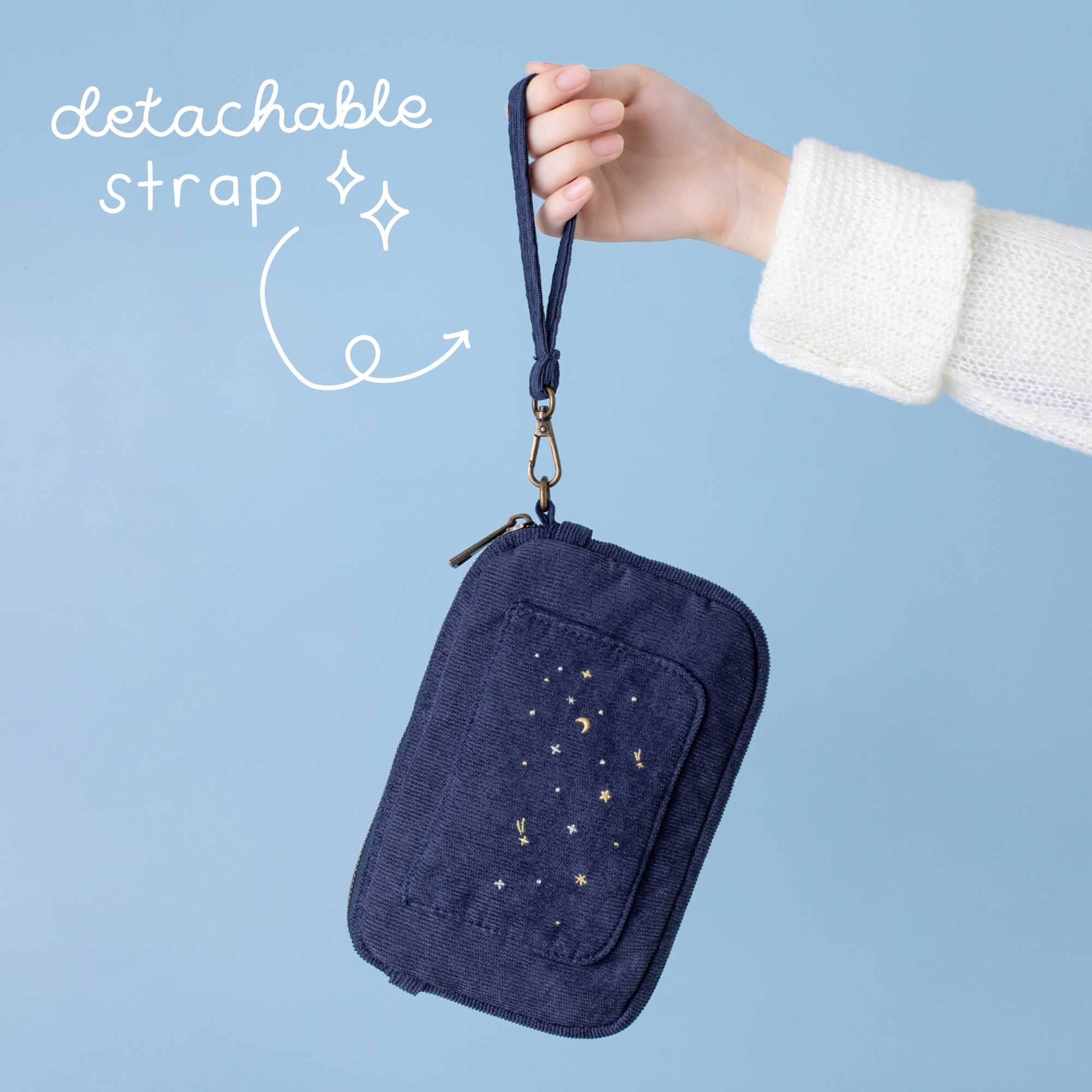 Tsuki ‘Cloud Dreamland’ travel pouch with detachable strap against blue background