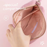 Open Tsuki ‘Sakura Journey’ Travel Pouch with special compartments held in hands on pink background