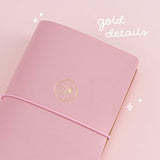 Close up of Tsuki ‘Sakura Journey’ Limited Edition Travel Notebook with gold details on pink background