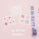 Three free sticker sheets and stamp tape from Tsuki ‘Sakura Journey’ Vintage Journal Washi Tape Set on pink background