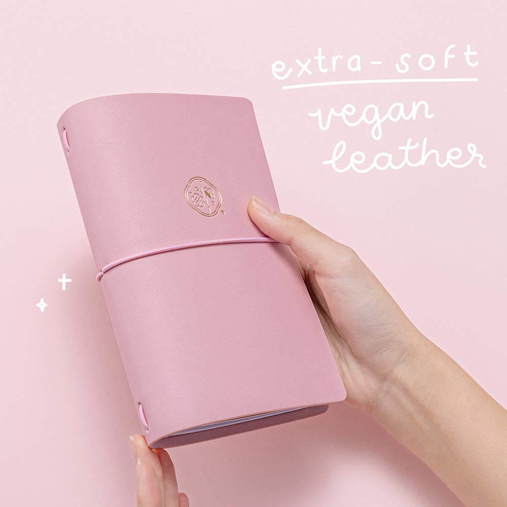 Tsuki ‘Sakura Journey’ Limited Edition Travel Notebook with extra soft vegan leather held in hands in pink background