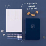 Tsuki ‘Winter Wishes’ Limited Edition Bullet Journal with reusable Tsuki gift box and free paperclip gift with Tsuki ‘Dreams of Snow’ Holographic Washi Tapes and Tsuki ‘Dreams of Snow’ Bullet Journal Stamps on navy background