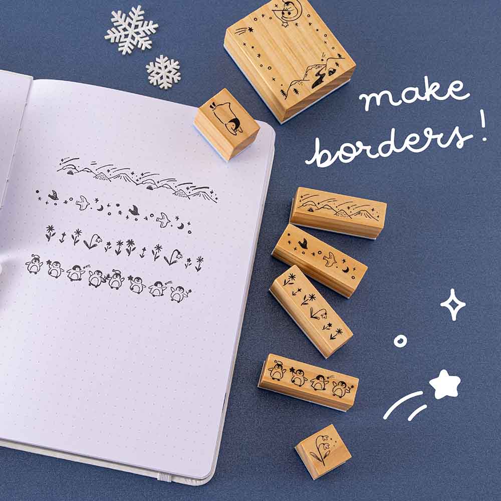 Tsuki ‘Dreams of Snow’ Bullet Journal Stamp Set to make banners with on open bullet journal page on navy background